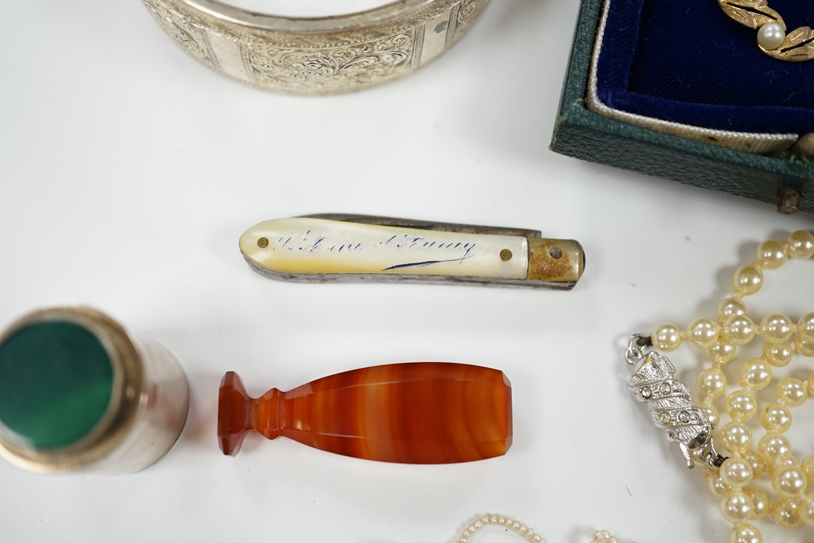 A modern 9ct gold and cultured pearl set circular brooch, 29mm, a silver hinged bangle, seed pearl necklace, a simulated pearl necklace, two seals, a 925 cannister and a pen knife.